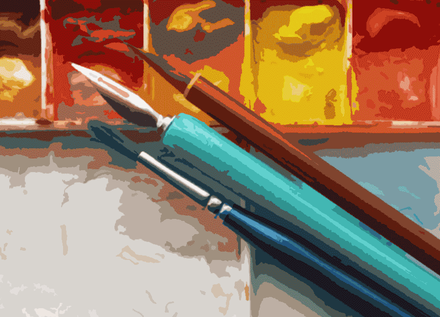 a pen and brushes with a warercolor paint palette
